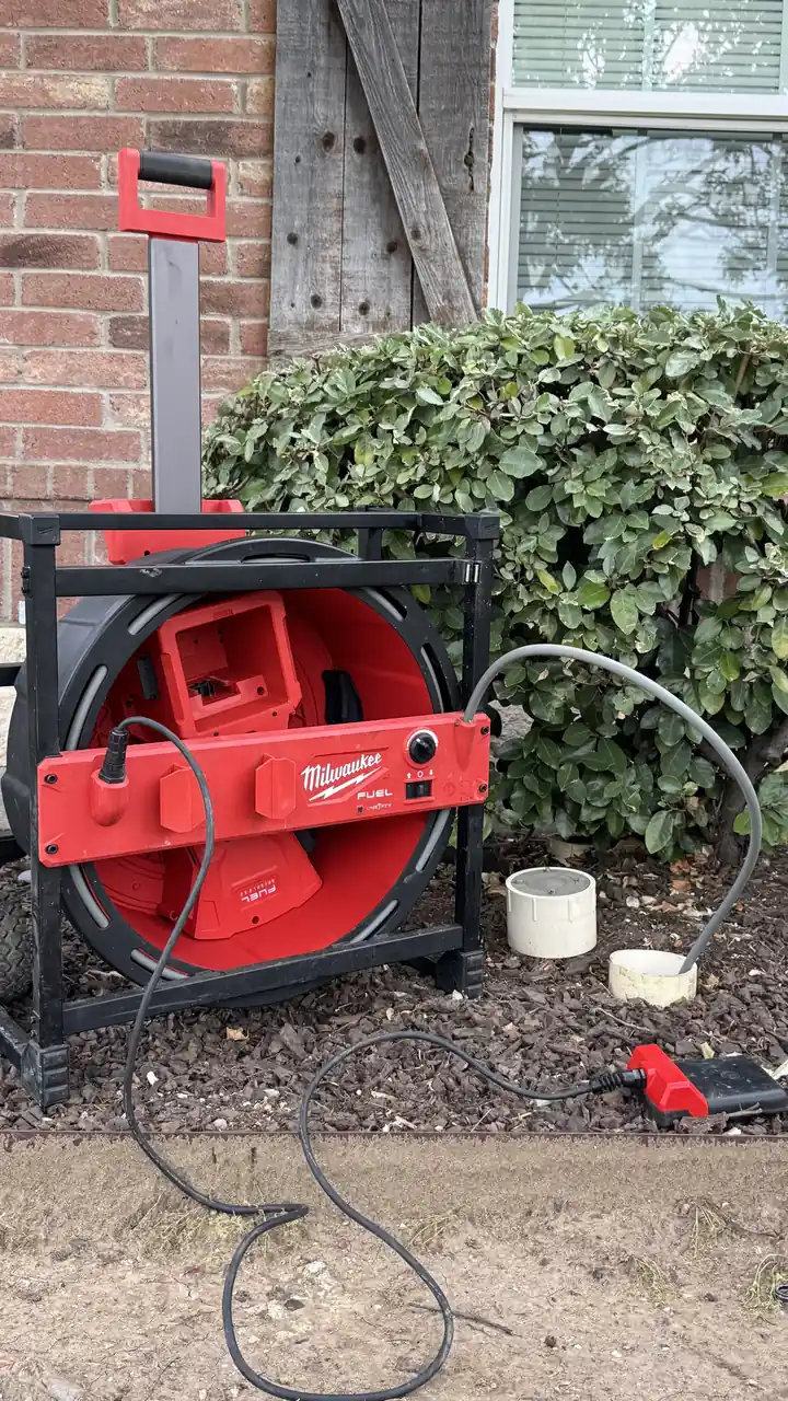 Milwaukee chain snake clearing a main drain line through an outside cleanout, Frisco