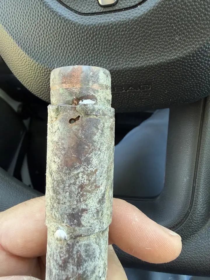 Cut out copper water line with pinholes corroded into large holes, Plano