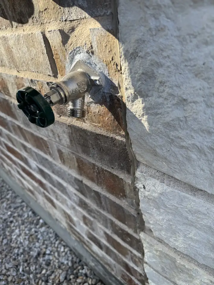 New frost free outside spigot set in a stone wall, Prosper