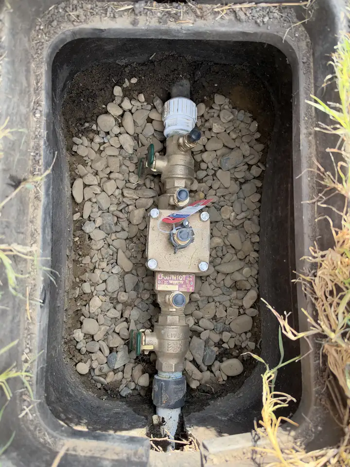 Replaced backflow preventer valve in a box with gravel, Frisco