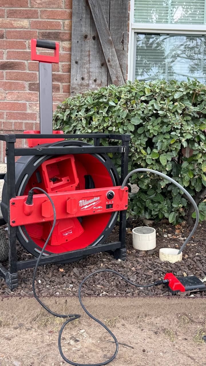 Drain cleaning with snake tool for clogged pipes in Frisco