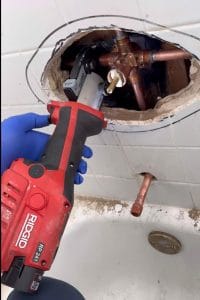 Opening tile to replace a corroded shower valve using RIDGID ProPress - FPP Plumbing Frisco