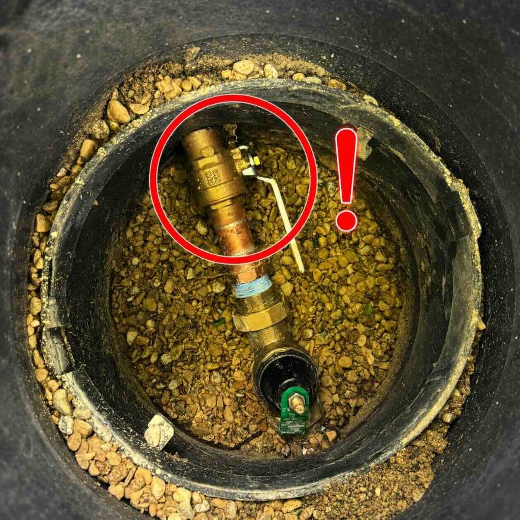 Inside the main shutoff valve and PRV box with the secondary shutoff valve marked in red