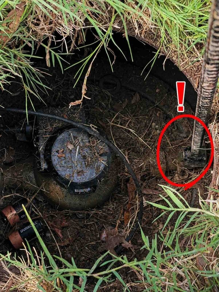 Water meter T key shutting off water at the main shutoff valve inside the meter box
