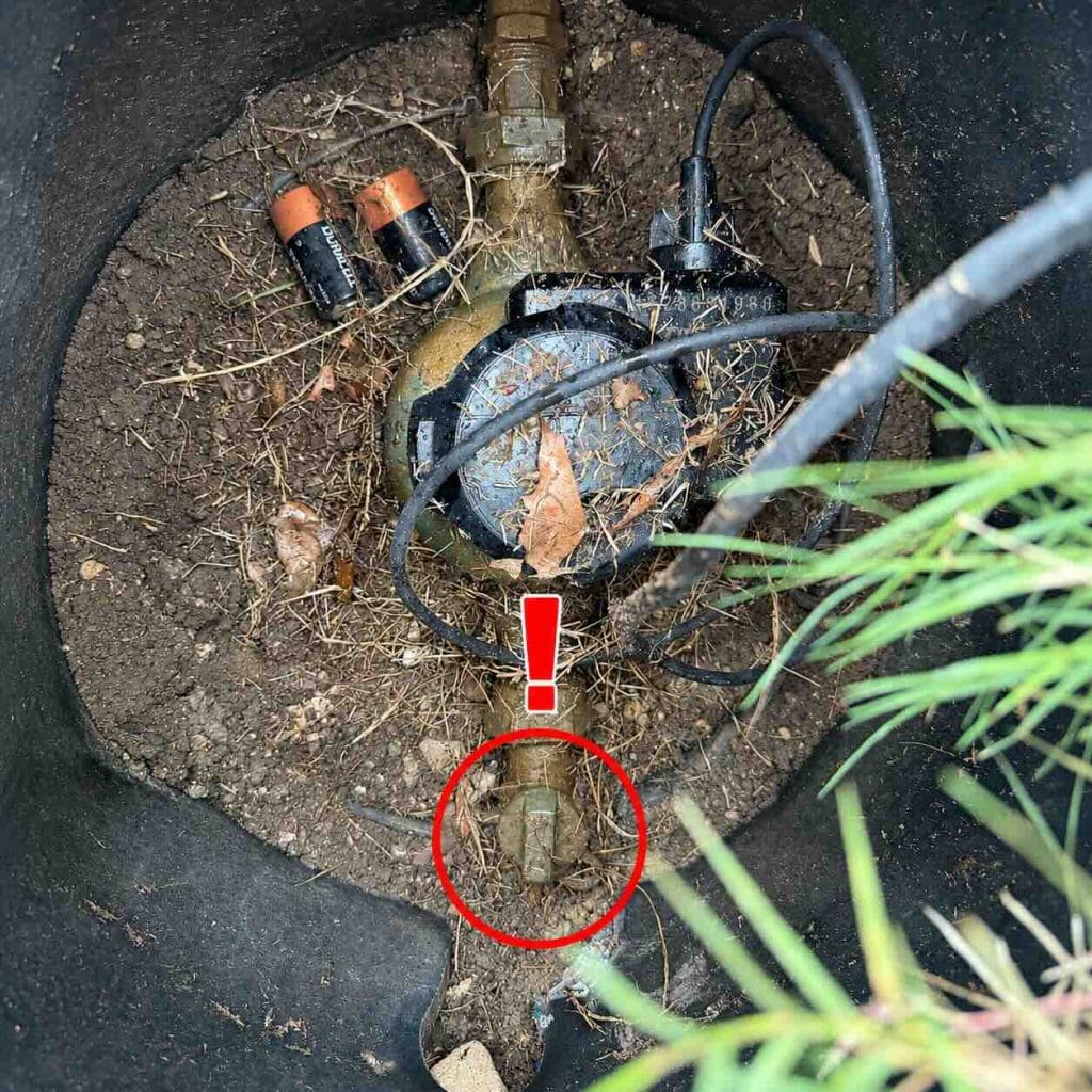 Main water meter and shutoff valve inside the meter box