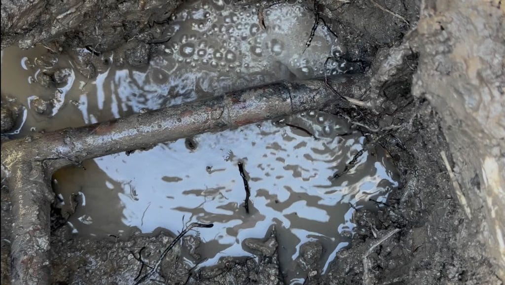 underground copper water line leak exposed in yard