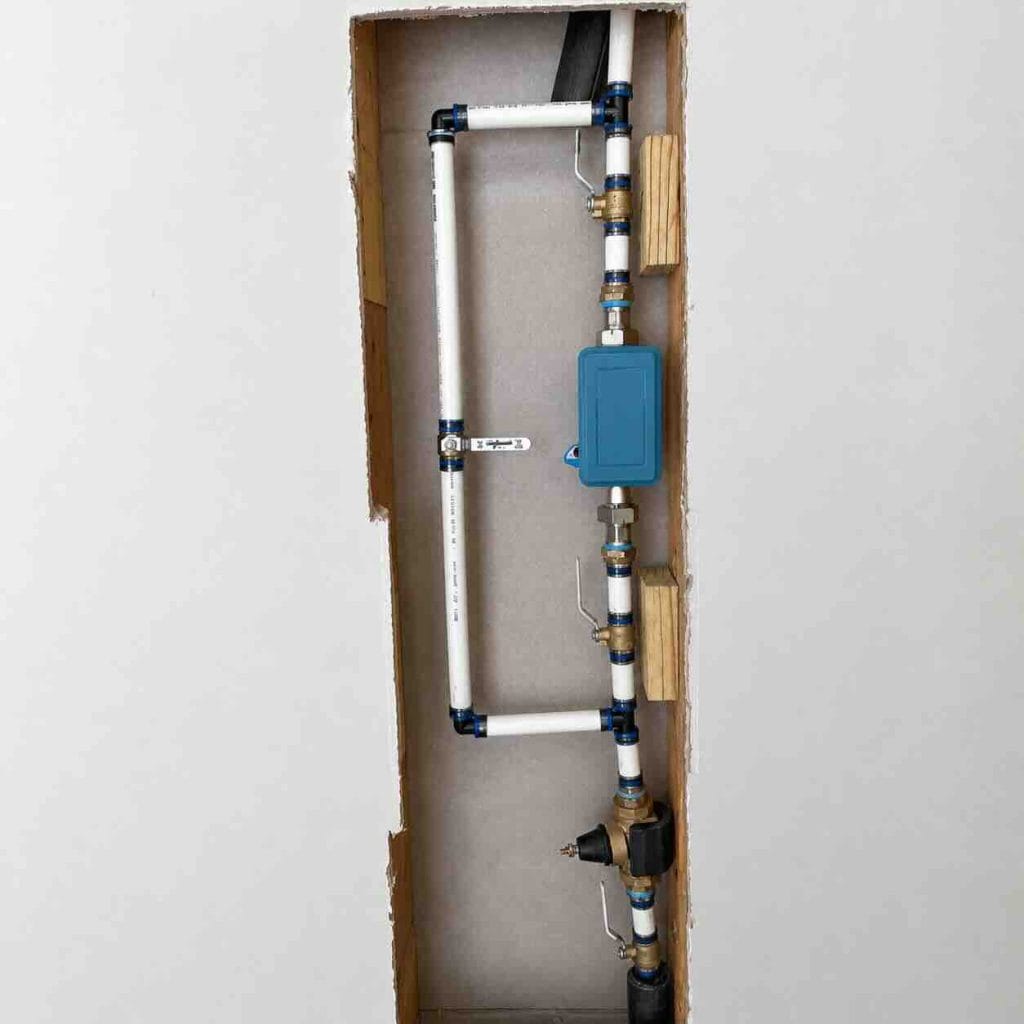 smart water shutoff valve installed near PRV in garage plumbing system