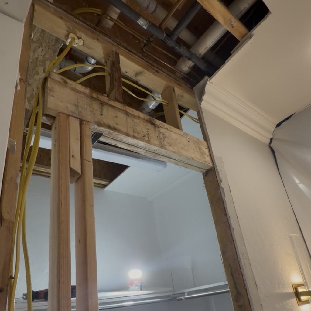 Opened wall and ceiling after bathroom leak damage in Frisco TX