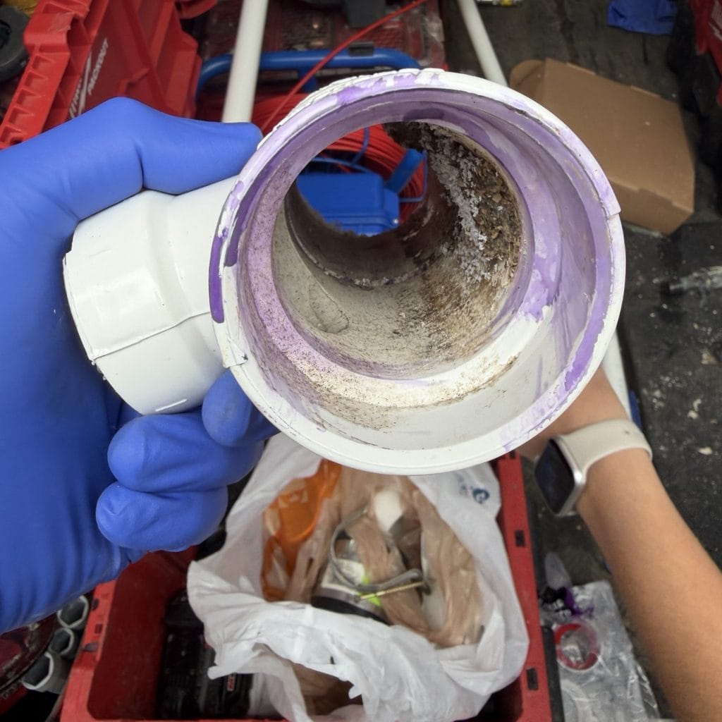 Removed unglued sanitary tee with buildup inside during bathroom leak repair in Frisco TX