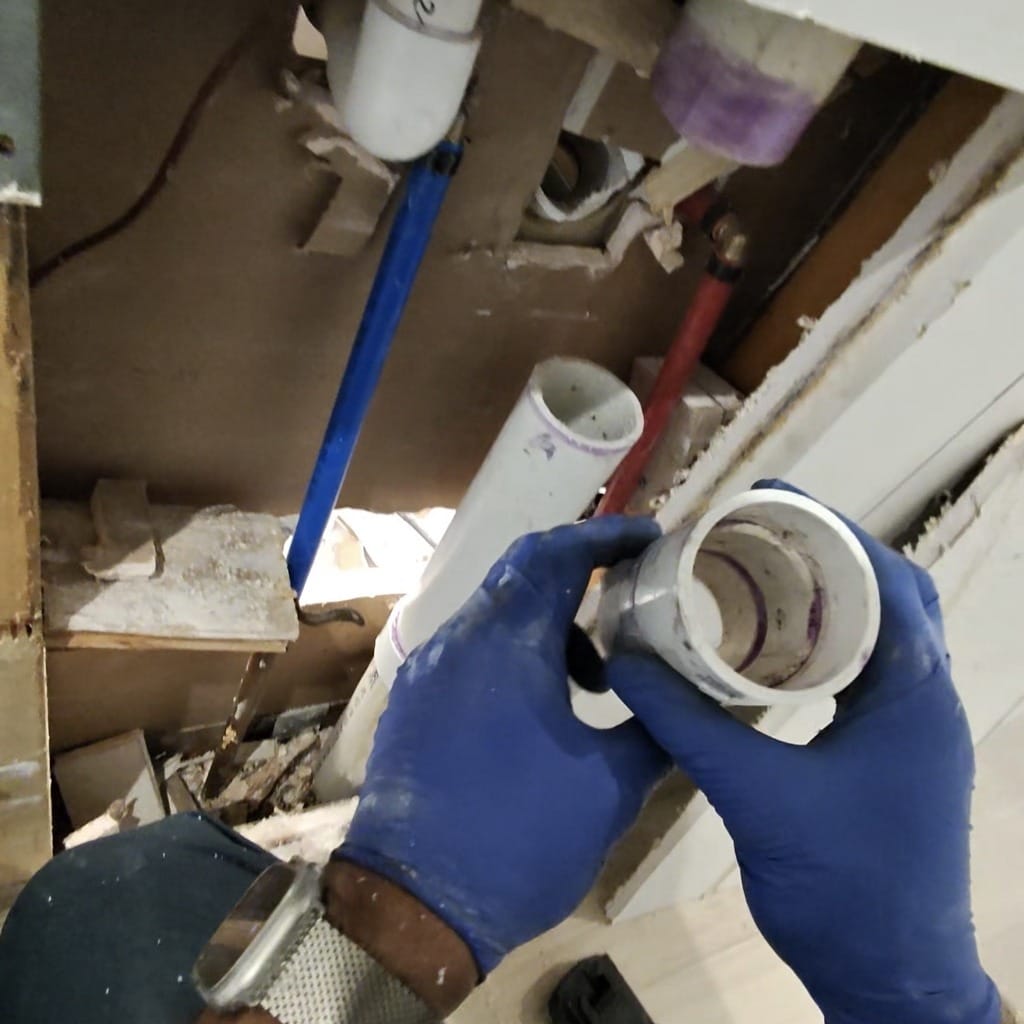 Removed sanitary tee showing no primer or PVC glue inside after bathroom remodel in Frisco TX